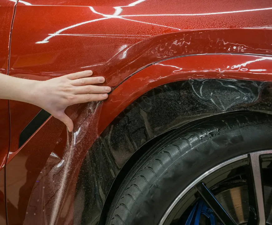 Paint Protection Film being installed around a wheel well