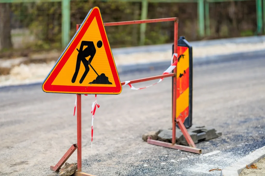 Current image: Construction hoarding signage promoting a future business opening in Calgary