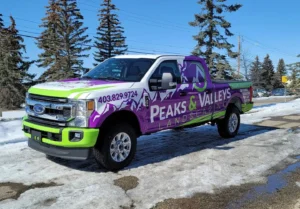 Branded commercial vehicle parked outside a Calgary business with storefront signage